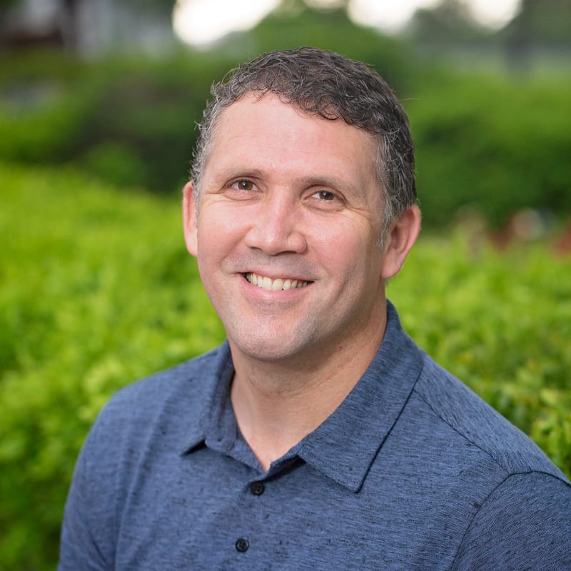 Ryan Robinson, Loan Officer at Alliance Lending Services, in a blue polo shirt outdoors